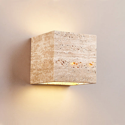 Square stone wall light fixture on a neutral background