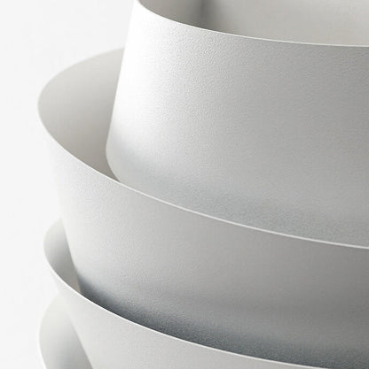 Stack of white bowls on a light gray background