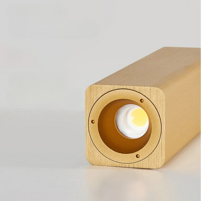 Wooden light fixture with a glowing interior on a gray background