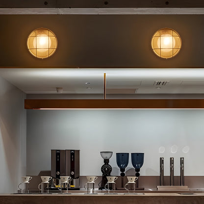 Modern kitchen setup with round lights on the ceiling and various kitchen appliances.