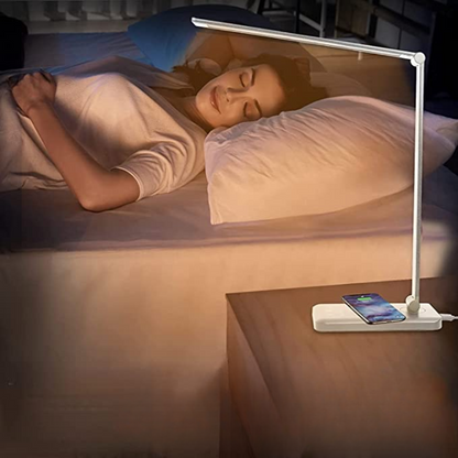 Woman sleeping in bed with a night light on a bedside table.
