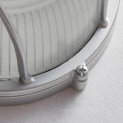 Close-up of a metallic object with a screw on a white background