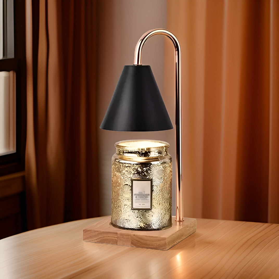 Decorative lamp with a black shade and gold accents on a wooden base, featuring a lit candle inside.