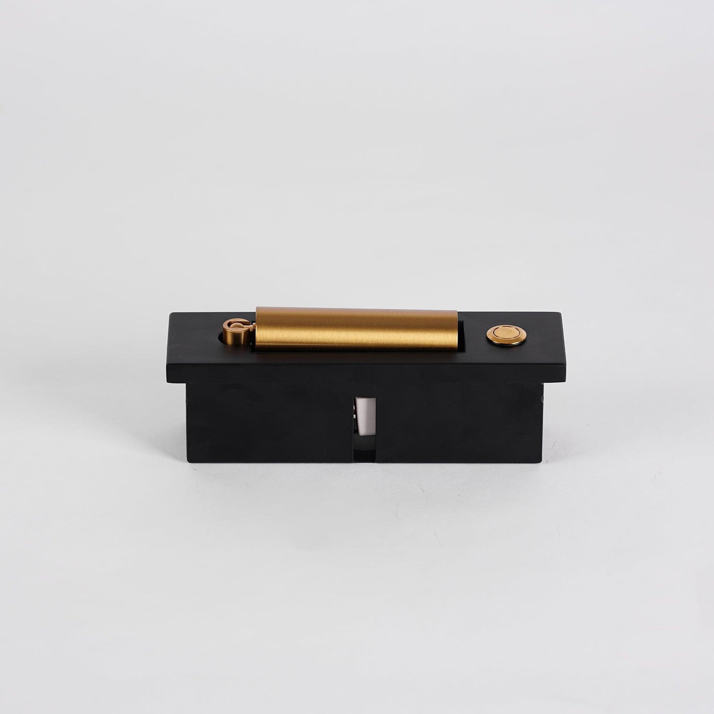 Black and gold mechanical device on a light gray background