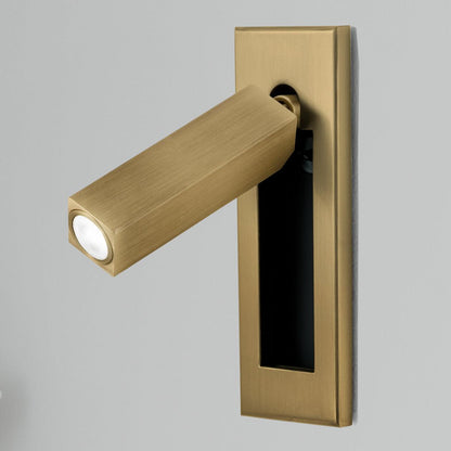 Gold wall light fixture on a gray background