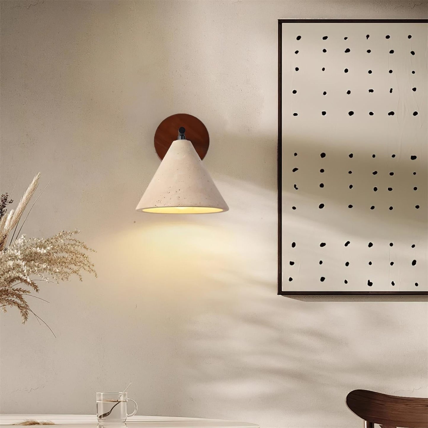 Wall-mounted lamp with a decorative frame on a wall in a room setting.