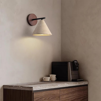 Modern wall lamp above a wooden console table with a coffee machine and cups.