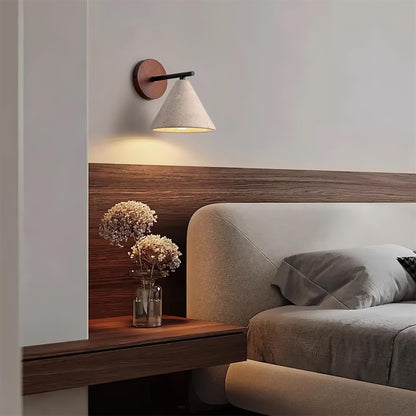 Modern bedroom with a wooden headboard, wall lamp, and decorative vase.