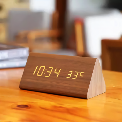 Wooden digital clock displaying time and temperature on a wooden surface