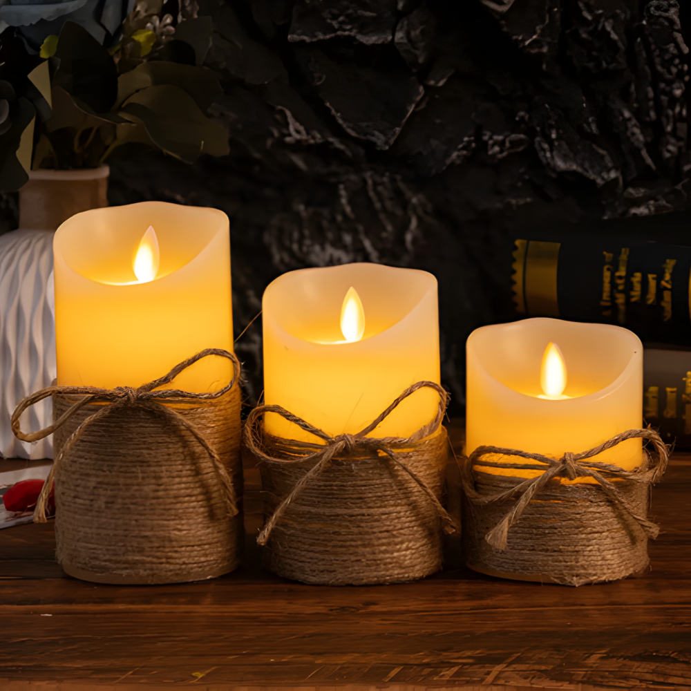 Three lit candles wrapped in twine on a wooden surface with a dark background