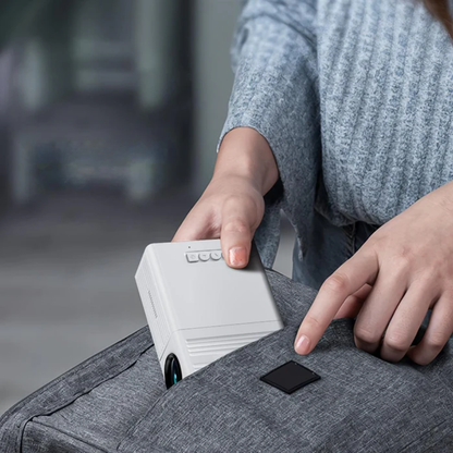 Person using a white electronic device on a gray suitcase with a blurred background