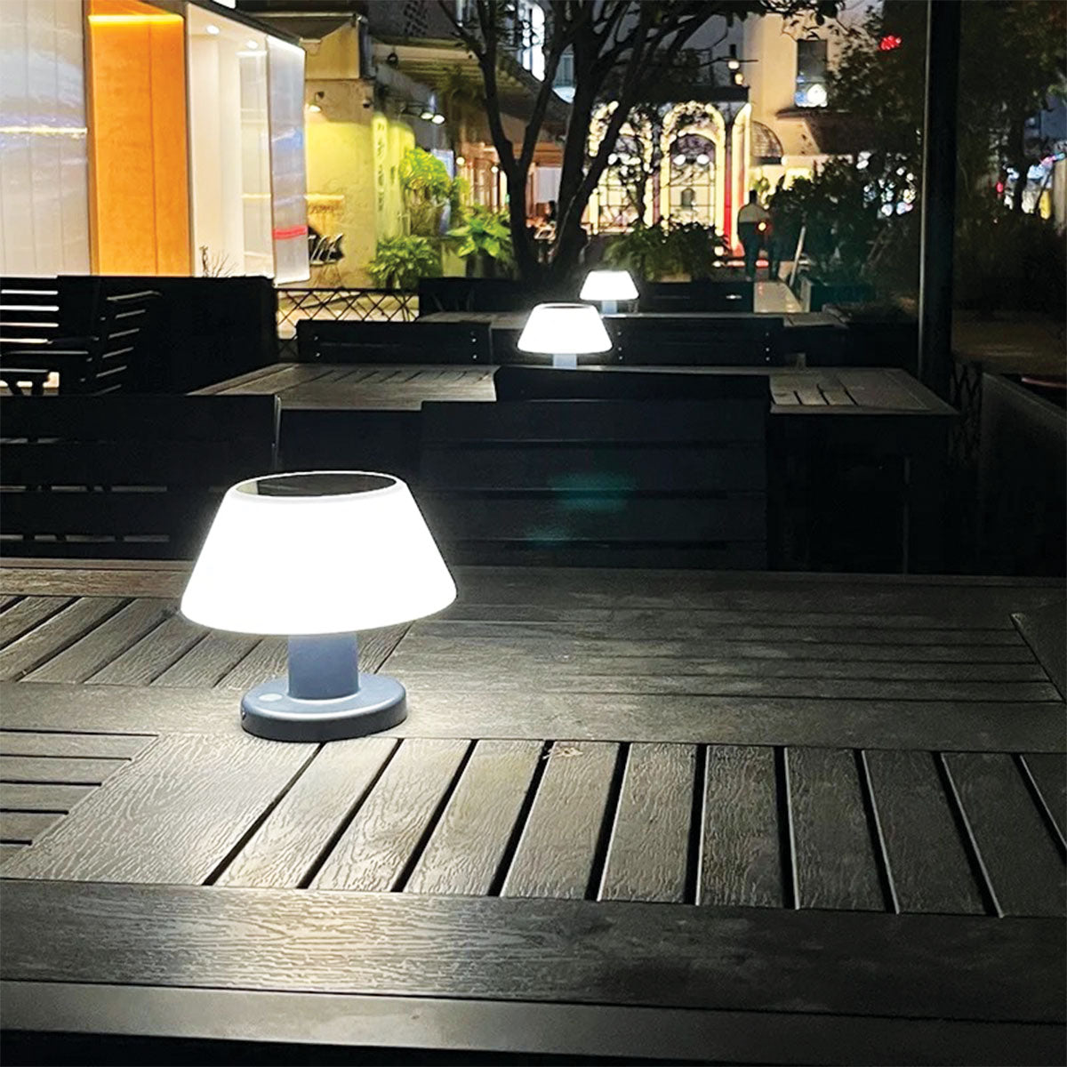 Outdoor setting with a table and lamp at night