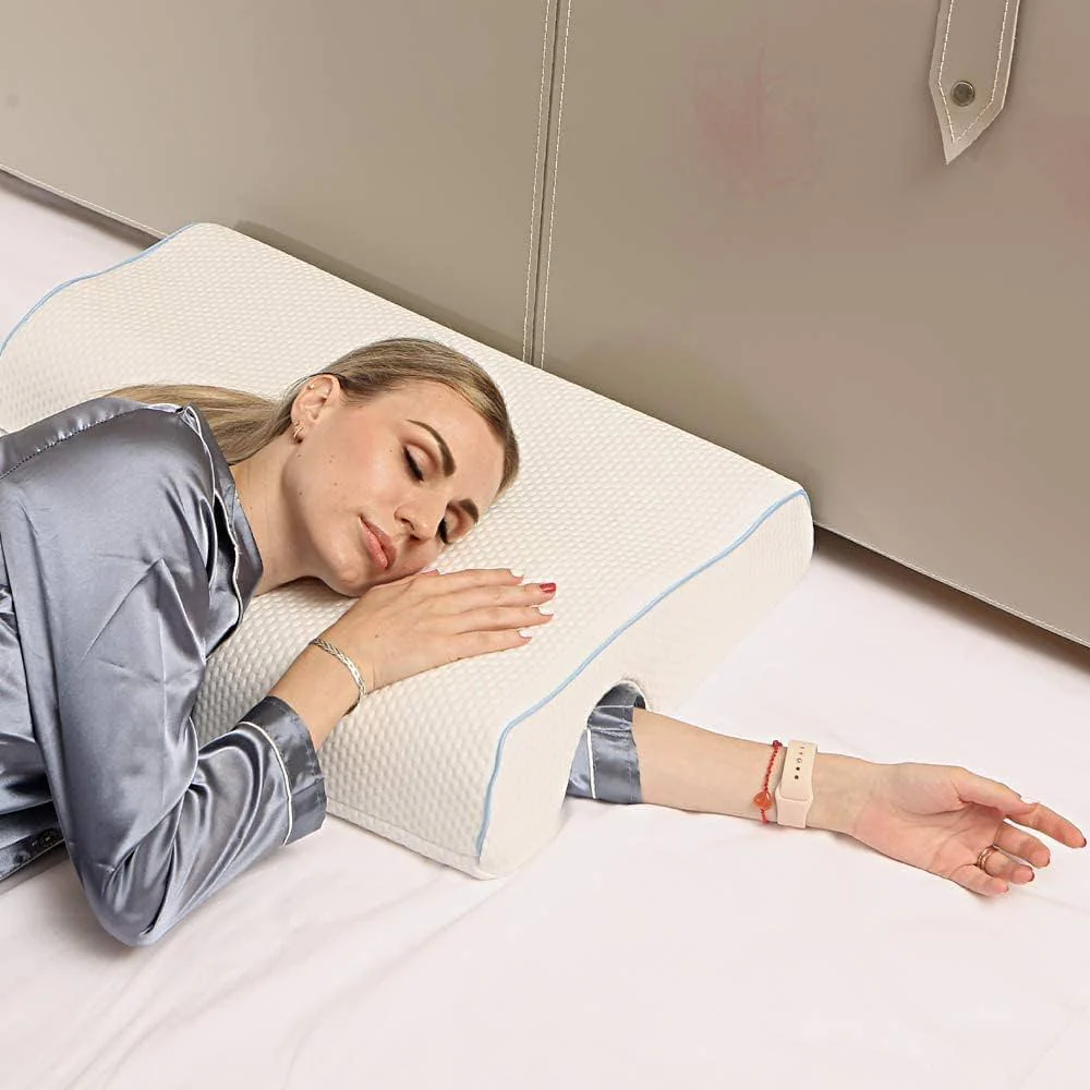 Woman lying on a bed with a white wedge-shaped pillow