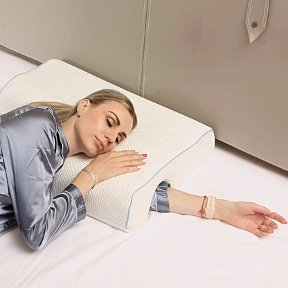 Woman lying on a bed with a white wedge-shaped pillow